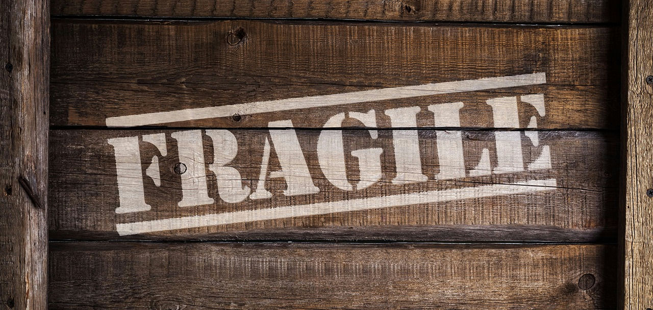 Wooden crate stencilled FRAGILE, ready for an insured courier delivery